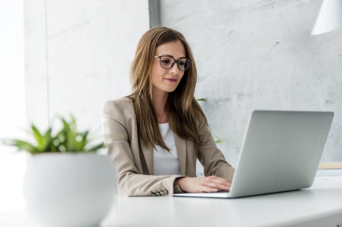 Corporate woman using laptop